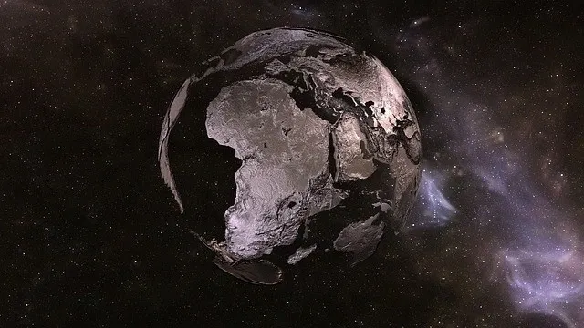 Monochrome Earth in space, with stars.